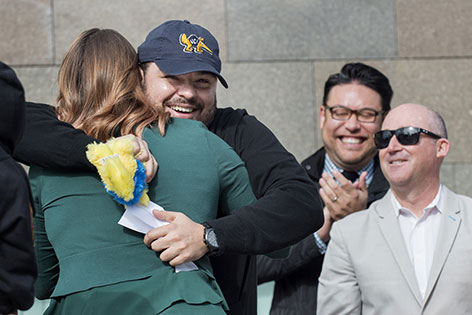 UC Irvine medical student is overjoyed to learn he has goes to his first choice of residency programs, UC Irvine Emergency Medicine. He hugs a relative as as Drs. Warren Wiechmann and Chris Fox cheer him on.